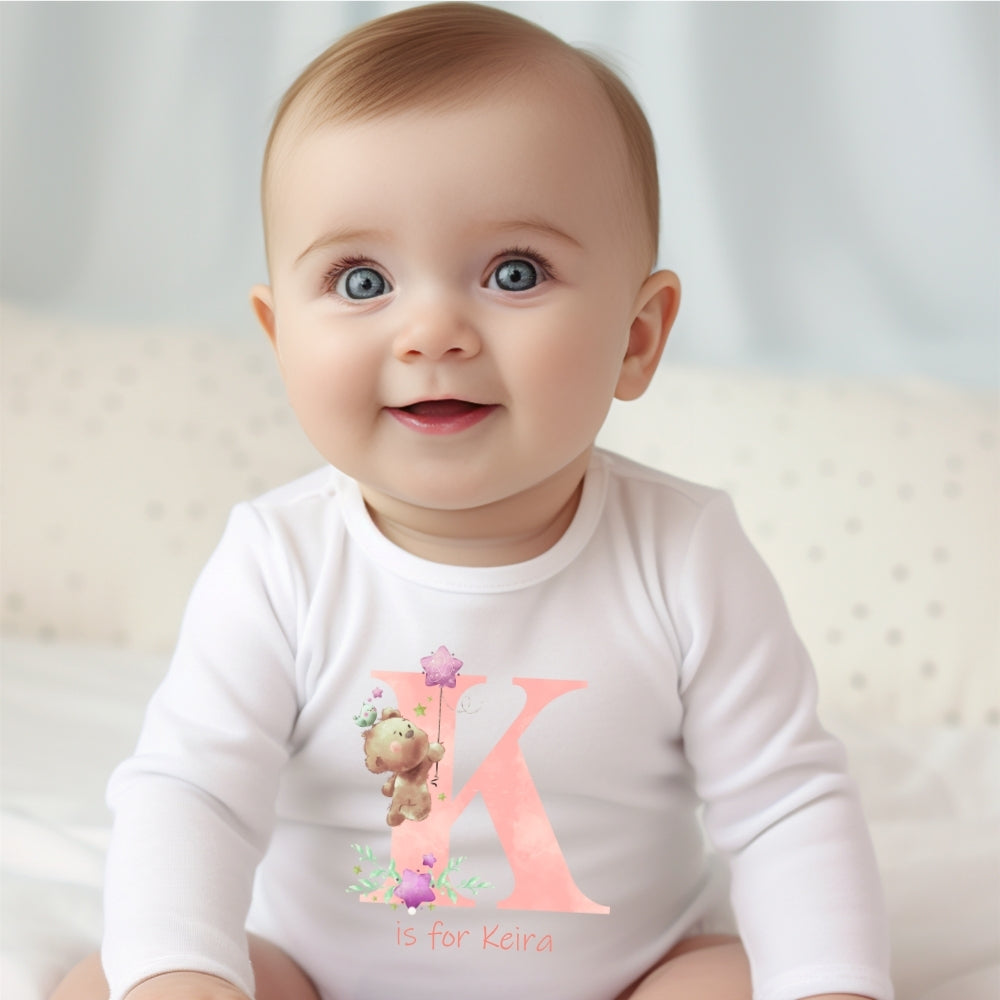 Personalised pink baby outfit featuring teddy bear motifs custom printed initial cotton bib and newborn vest