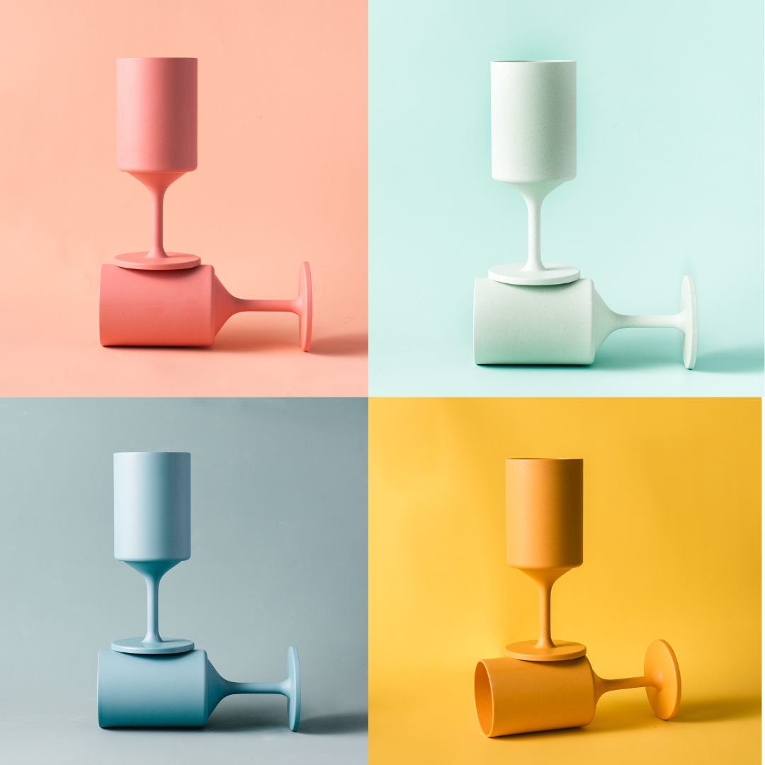 Four colorful reusable outdoor wine glasses in orange, coral, aqua, and teal made from bamboo
