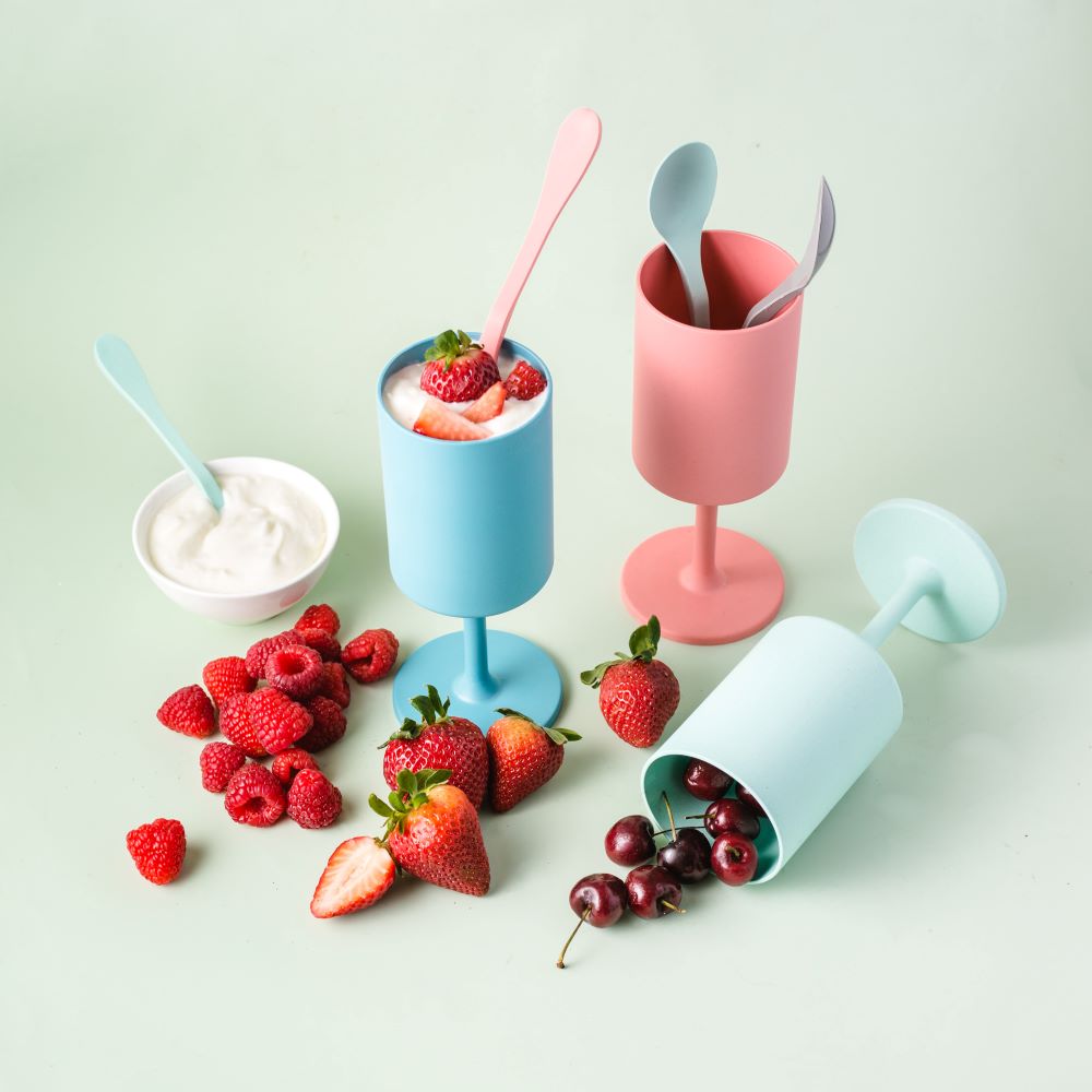 Four colorful reusable outdoor wine glasses in orange, coral, aqua, and teal made from bamboo — view 4