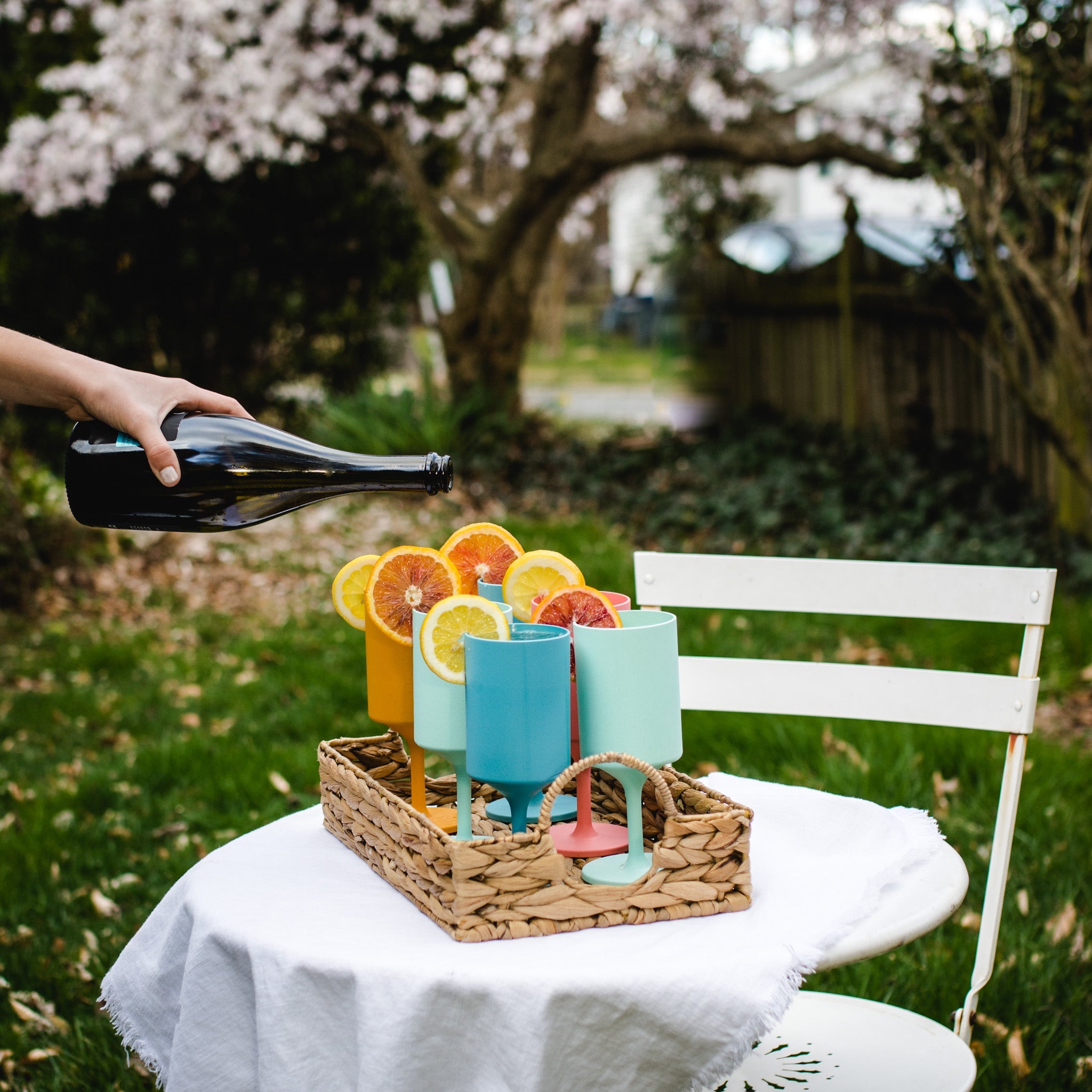 Four colorful reusable outdoor wine glasses in orange, coral, aqua, and teal made from bamboo — view 2