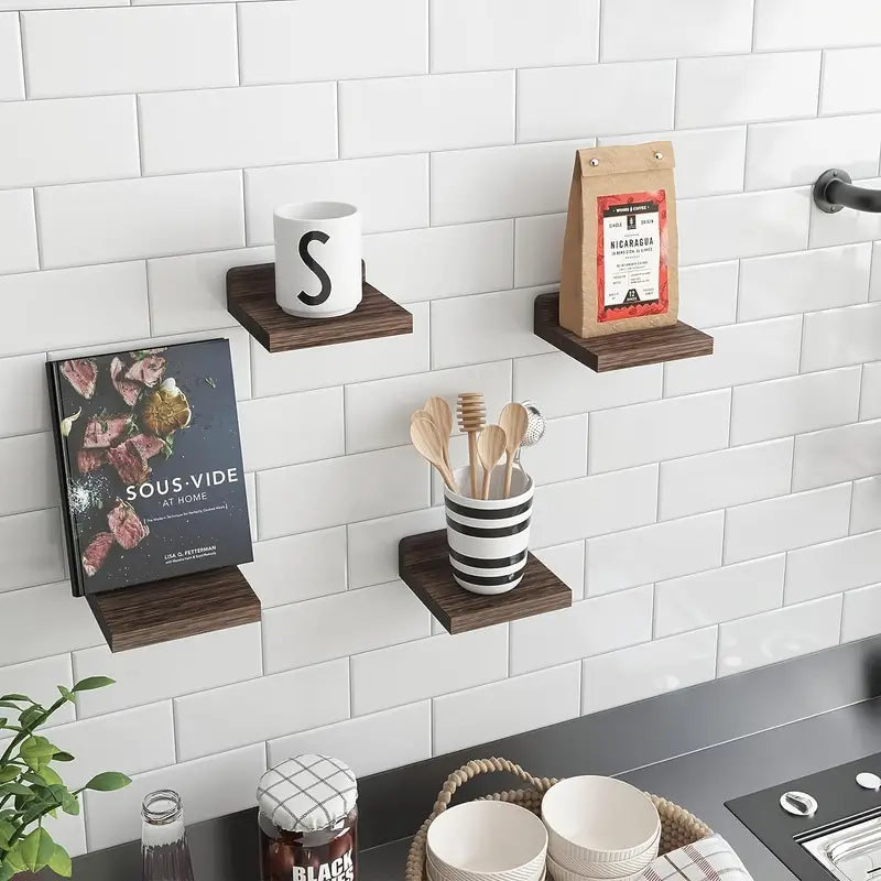 Four piece black wooden floating wall shelves displaying small potted plants and books — view 5
