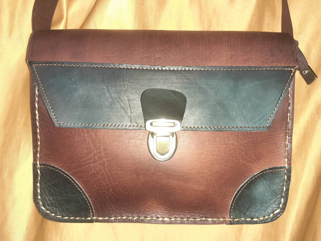 Two-tone leather crossbody bag with rustic finish, front zipper pocket, and long adjustable shoulder strap — view 4