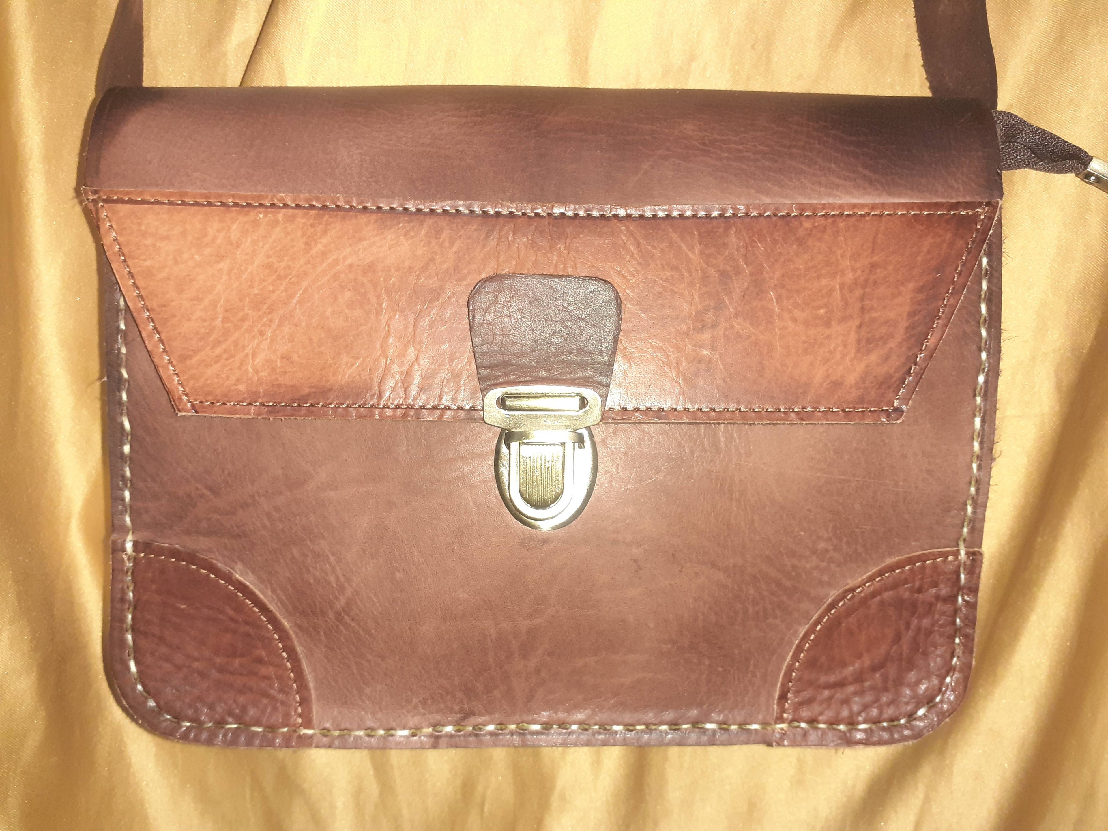 Two-tone leather crossbody bag with rustic finish, front zipper pocket, and long adjustable shoulder strap — view 9