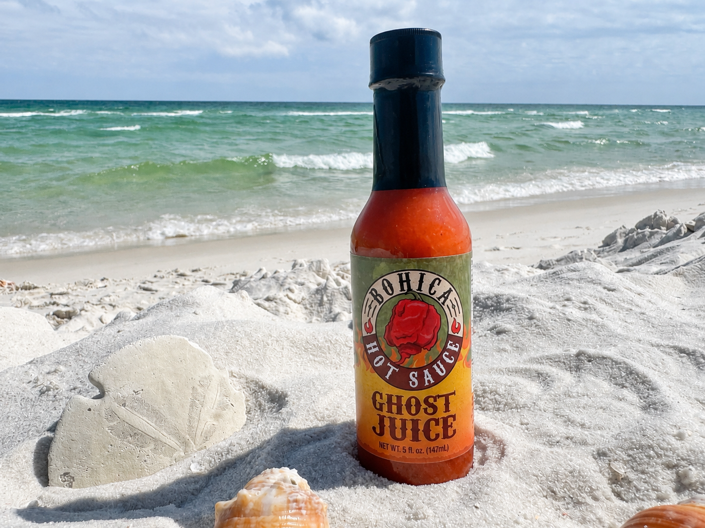 Bottle of Ghost Juice hot sauce featuring a vibrant fruity ghost pepper blend