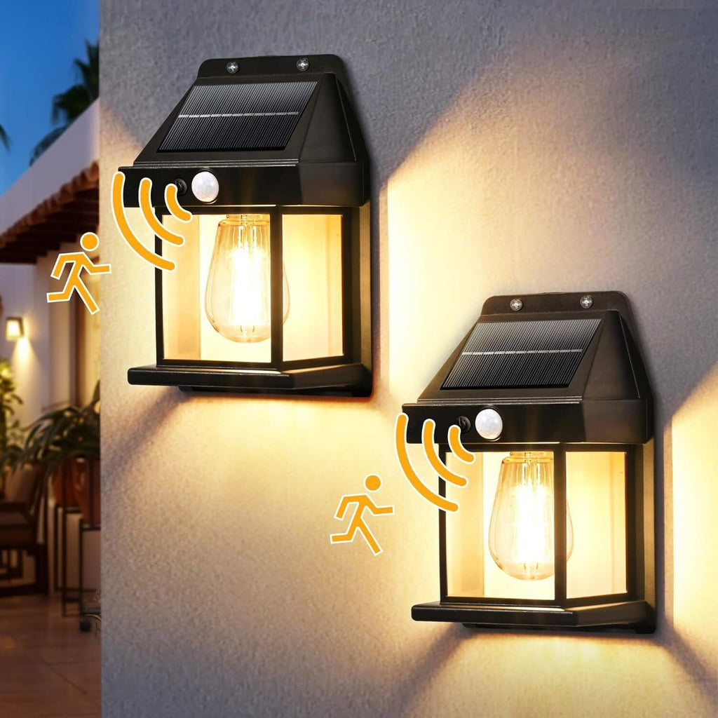 Two black plastic solar motion sensor LED outdoor security lights mounted on a wall — view 3