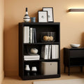 Black three-tier adjustable wooden bookcase displaying books and decor for home office storage.
