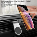 Black magnetic air vent car cell phone holder attached to a vehicle dashboard air vent