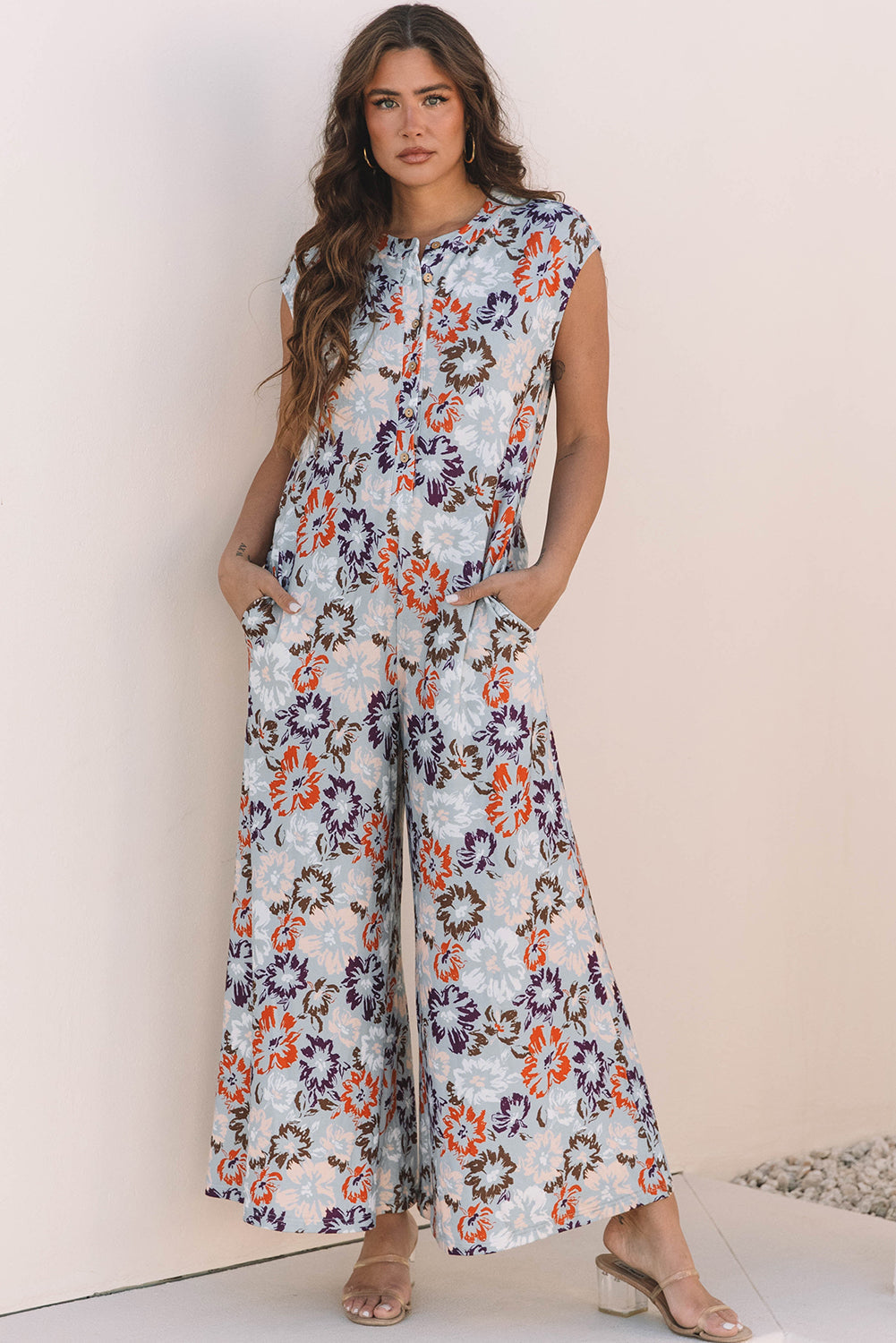 Floral sleeveless wide leg jumpsuit in blue with half button front and side pockets — view 4