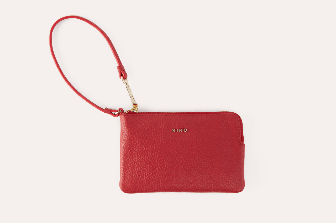Small genuine pebble leather wristlet with attached strap and zip closure for women