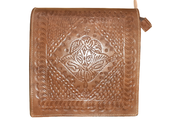 Square rustic cowhide crossbody bag with a carved leather flap and a secure magnetic closure