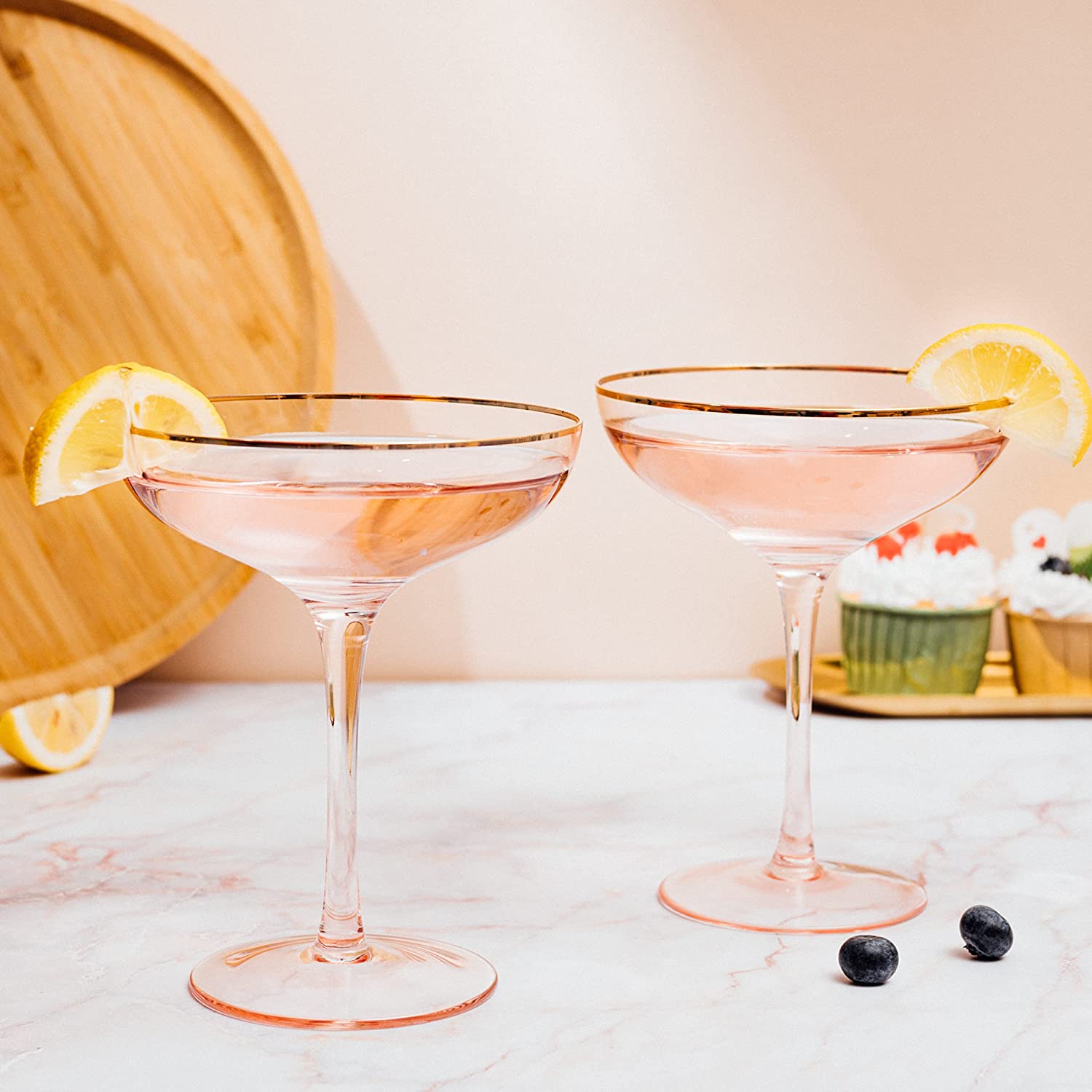 Set of two blush pink stemless coupe glasses with gold gilded rims and bubble design. — view 2