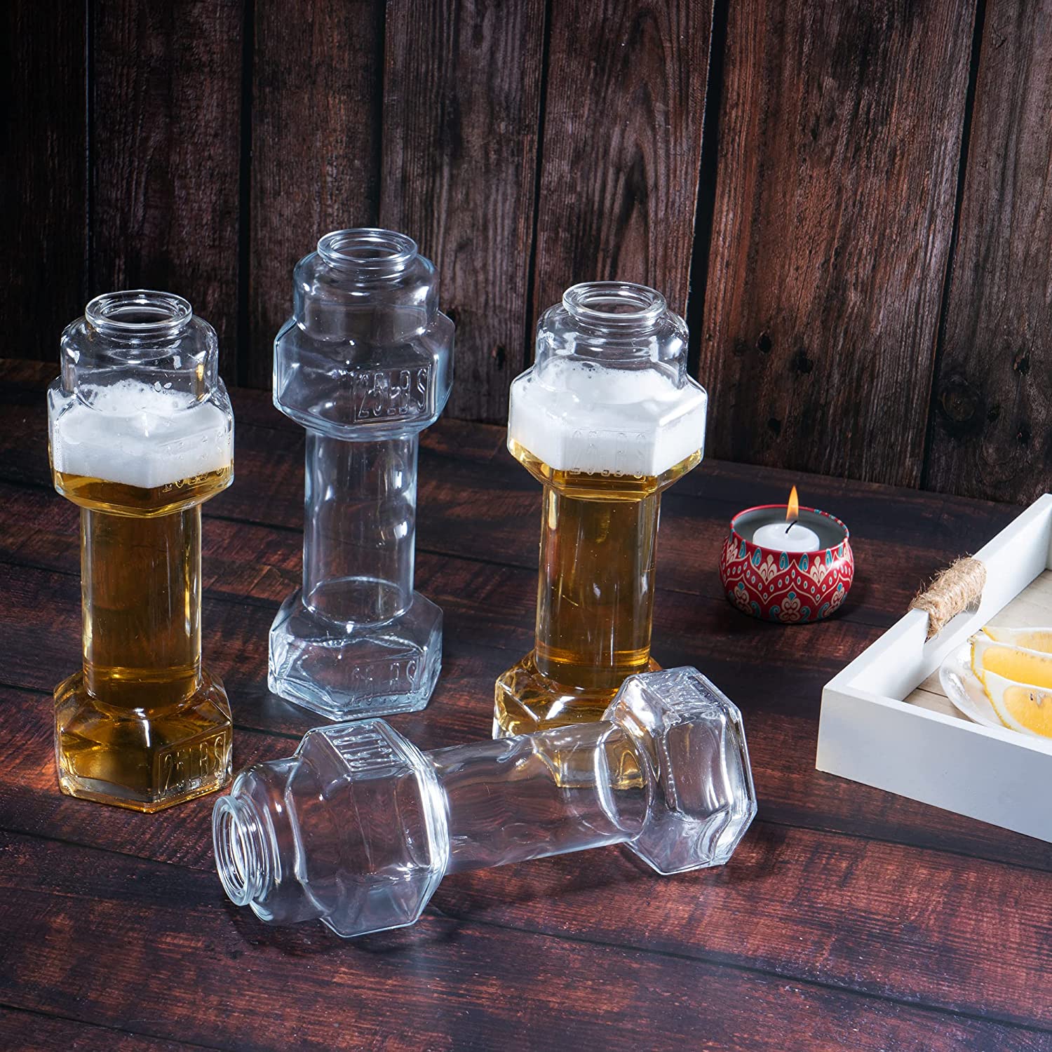 Set of four clear hollow glass dumbbell shaped novelty whiskey and beer drinking glasses — view 4