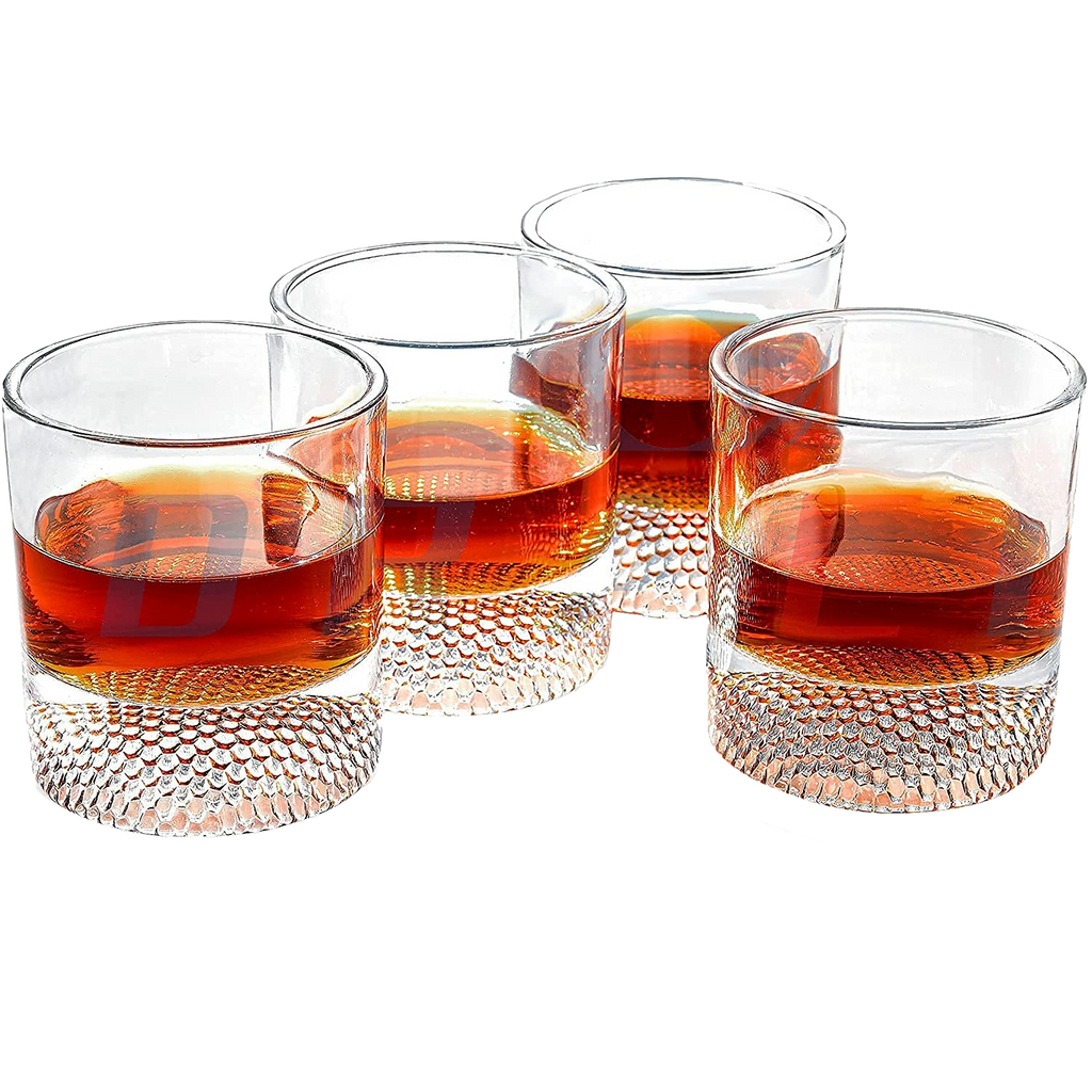 Set of four clear whiskey glasses with a textured golf ball base for home bars