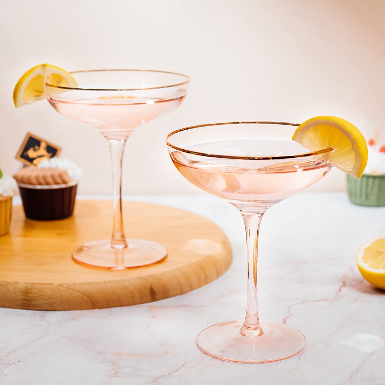 Set of two blush pink stemless coupe glasses with gold gilded rims and bubble design. — view 3