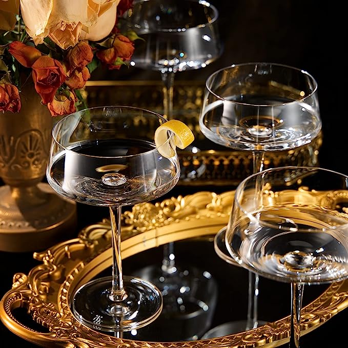 Four luxury glass martini coupes with an elegant silver mixing spoon for cocktail entertaining — view 2