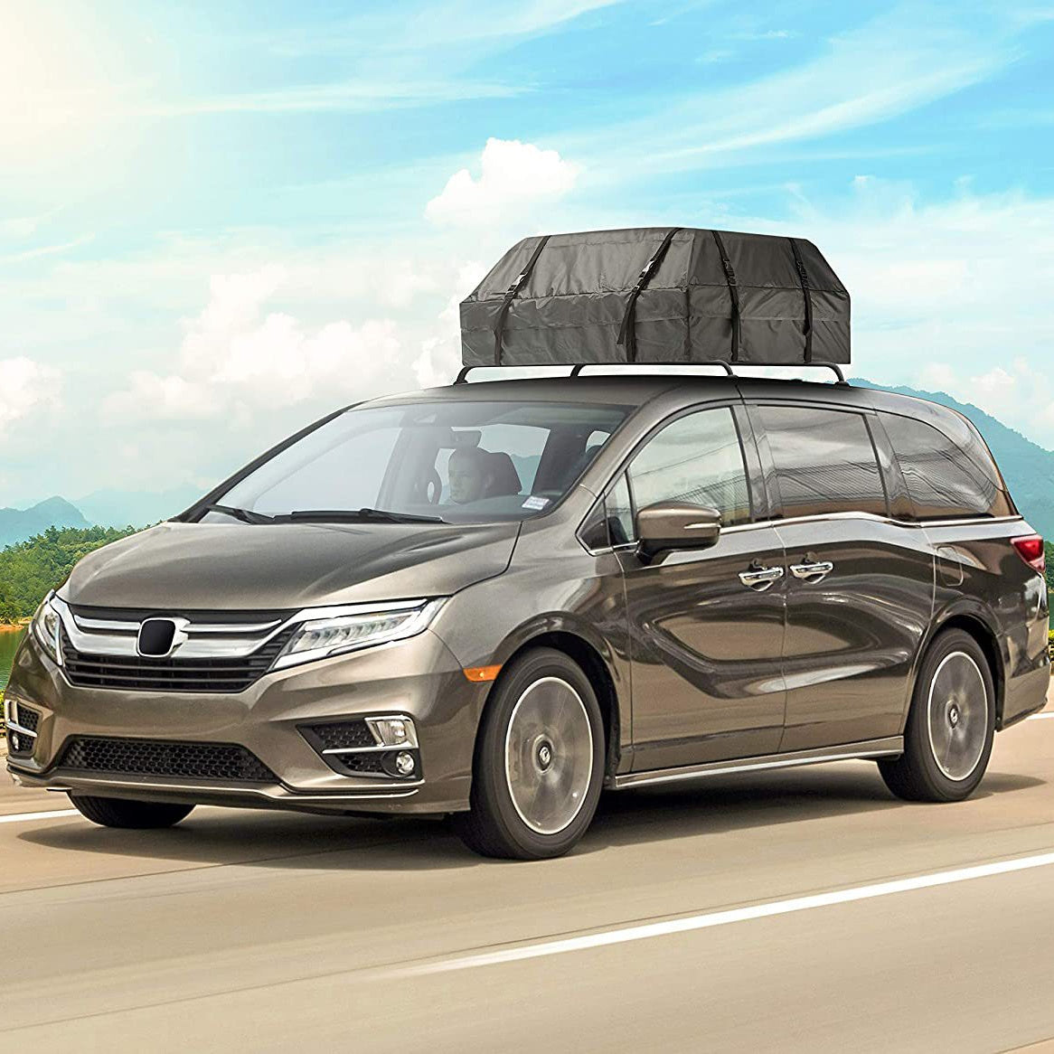 Waterproof ABS roof cargo box with orange trim, mounted securely on a vehicle roof rack — view 3