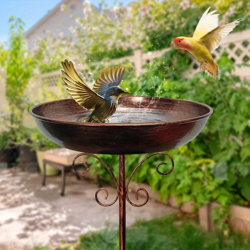 Vintage metal bird bath with copper finish on a sturdy pedestal stand in an outdoor garden — view 2