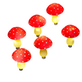 Set of 8 red solar mushroom garden lights illuminating a grass pathway with warm white LEDs
