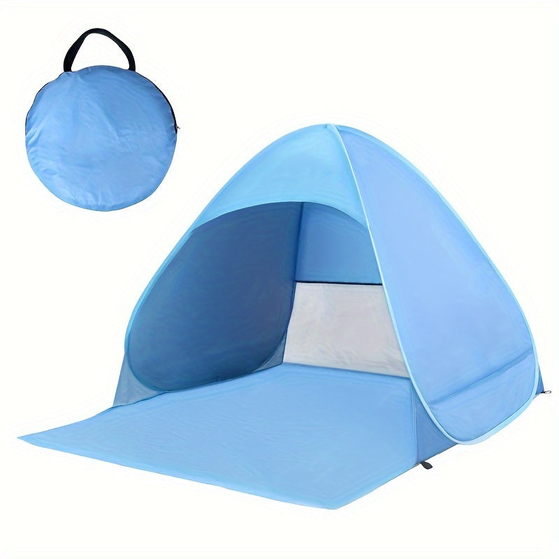 Portable waterproof beach tent in blue with sunshade pitched outdoors on sand