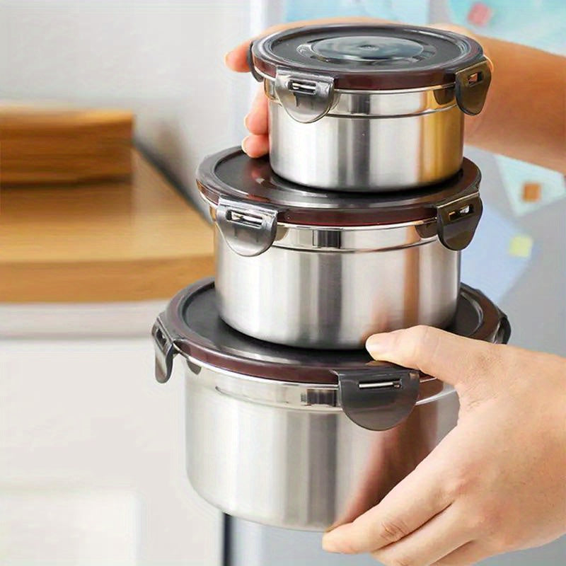 Three round stainless steel food storage containers with black leakproof clip-on lids — view 5