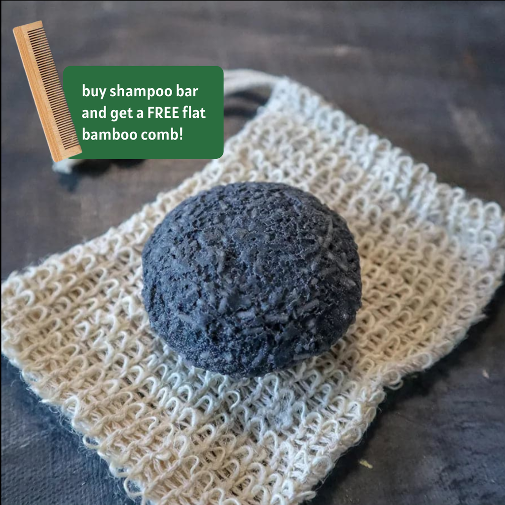 Solid charcoal rebalancing shampoo bar for oily hair placed on a natural wooden soap dish. — view 2