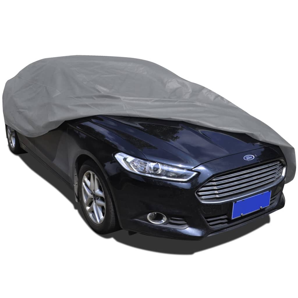 Medium grey nonwoven car cover securely fitted over a sedan for outdoor weather protection