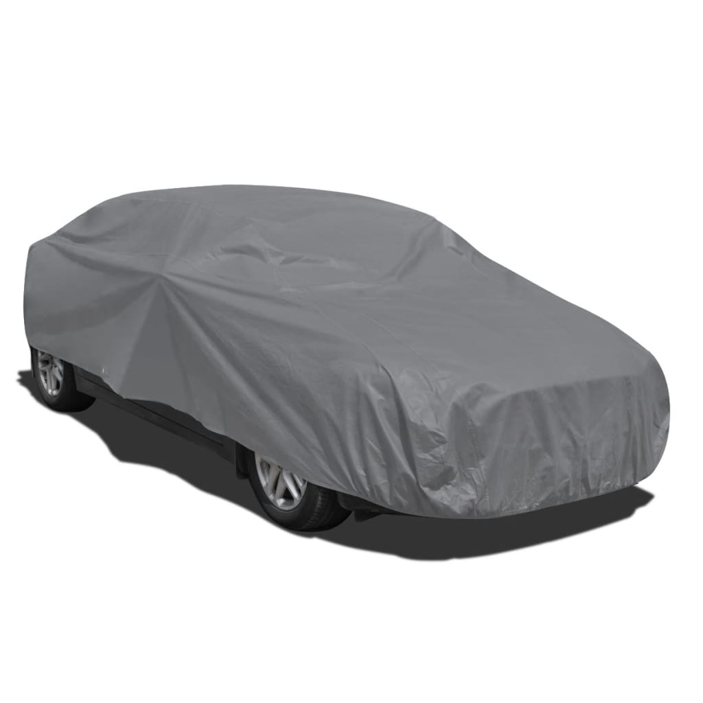 Medium grey nonwoven car cover securely fitted over a sedan for outdoor weather protection — view 3