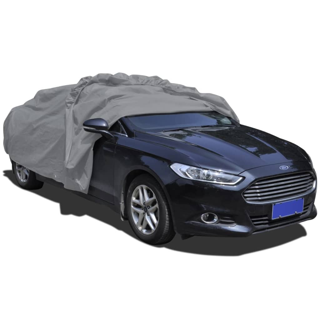 Medium grey nonwoven car cover securely fitted over a sedan for outdoor weather protection — view 4