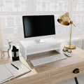 White engineered wood monitor stand and desktop riser with integrated storage shelf.
