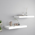 Two white modern minimalist floating wall shelves mounted seamlessly in a contemporary home setting