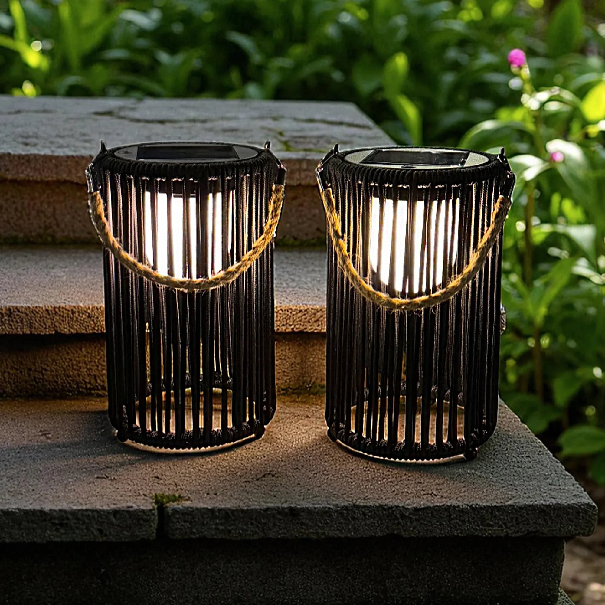 Two black metal 10.5 inch outdoor solar lanterns with rustic jute rope handles for garden lighting