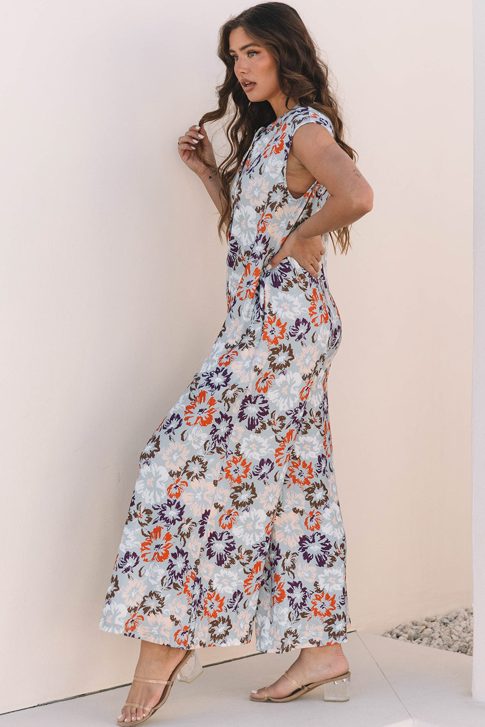 Floral sleeveless wide leg jumpsuit in blue with half button front and side pockets — view 3