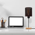 Industrial wire cage table lamp with a natural wood stand and exposed E27 Edison bulb