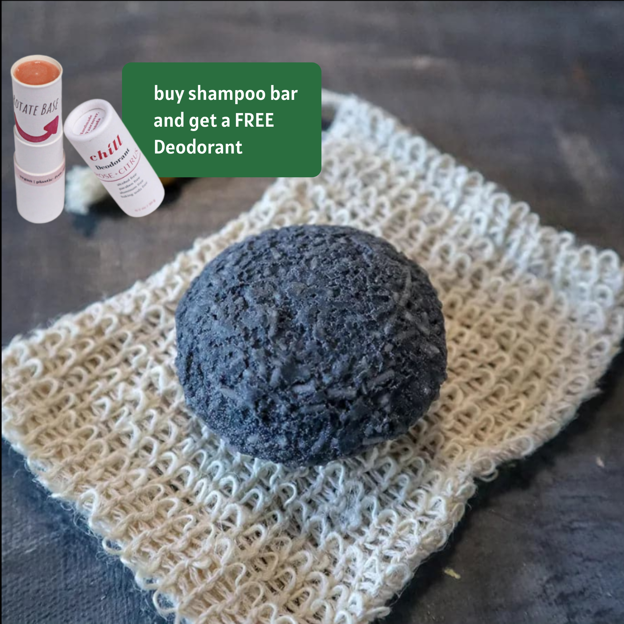 Solid charcoal rebalancing shampoo bar for oily hair placed on a natural wooden soap dish.