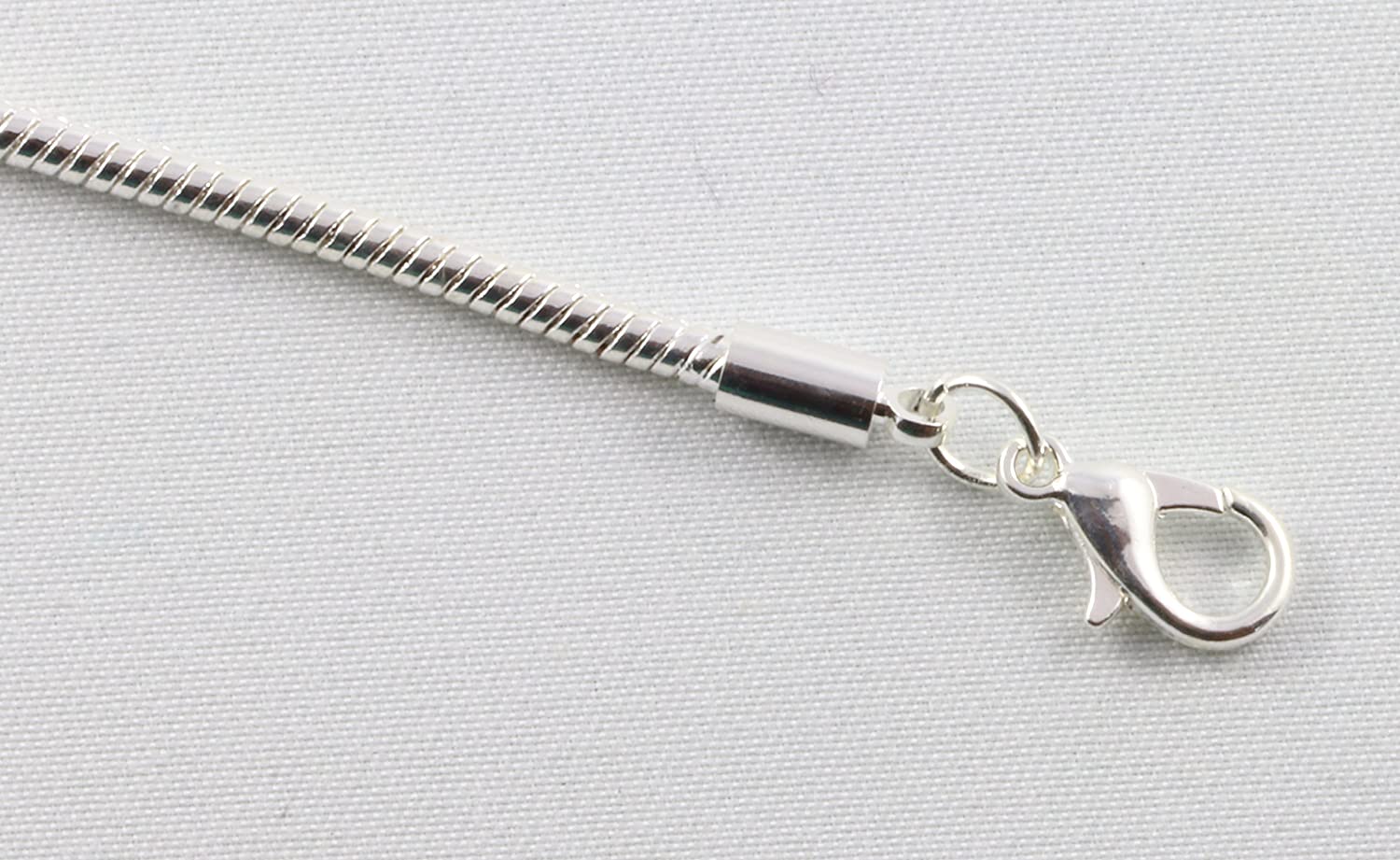 Silver plated Fleur de Lis charm bracelet on a sleek snake chain for men and women — view 3