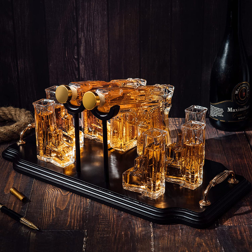 Double pistol whiskey decanter set with six shot glasses on a wooden display stand — view 3