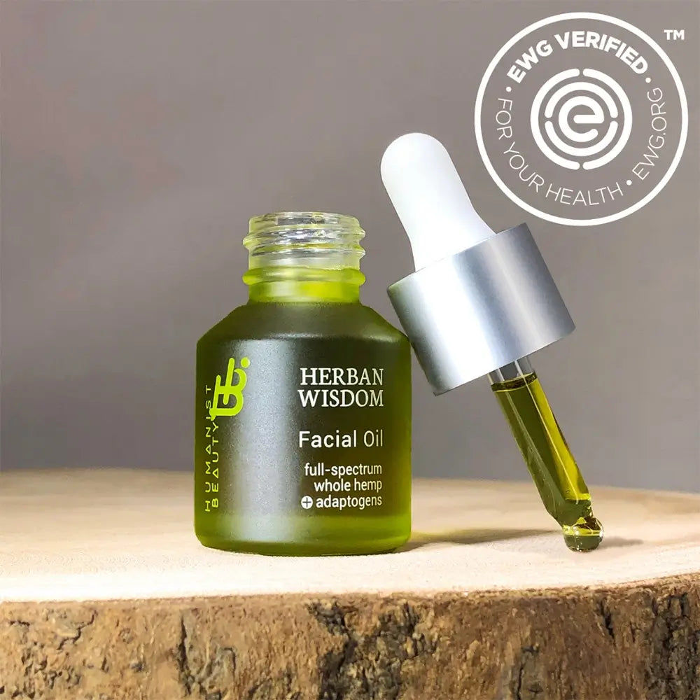 Herban Wisdom facial oil in half size dropper bottle, featuring botanical extracts for glowing skincare.