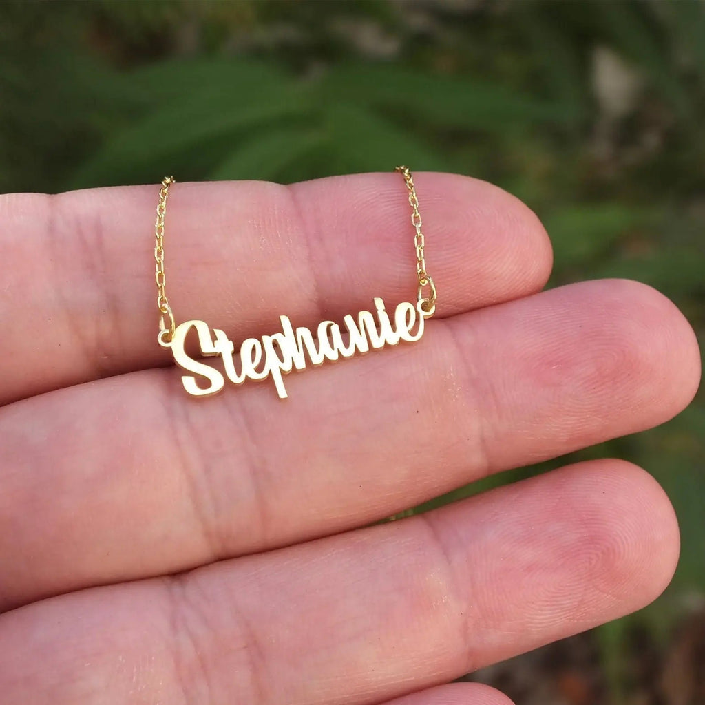 Personalized name necklace in elegant script font with a delicate gold chain and clasp. — view 3