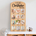 Custom wooden baby milestone photo board displaying twelve months of pictures with personalized cut out name