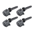 Set of four black automotive tire pressure monitoring sensors with metal valves.