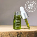 Herban Wisdom Facial Oil mini travel bottle with botanical serum for glowing skin