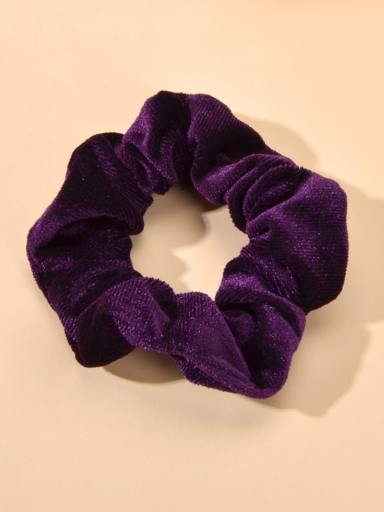 Retro velvet elastic scrunchie hair tie displaying soft fabric texture and flexible circular shape — view 2