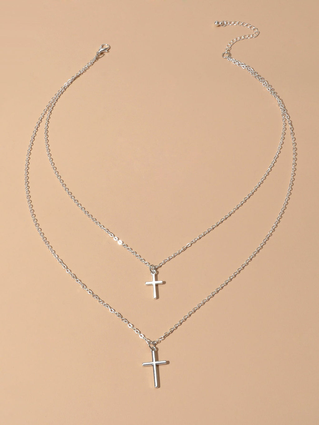 Silver double layer cross necklace featuring delicate chains and a minimalist pendant for women — view 2