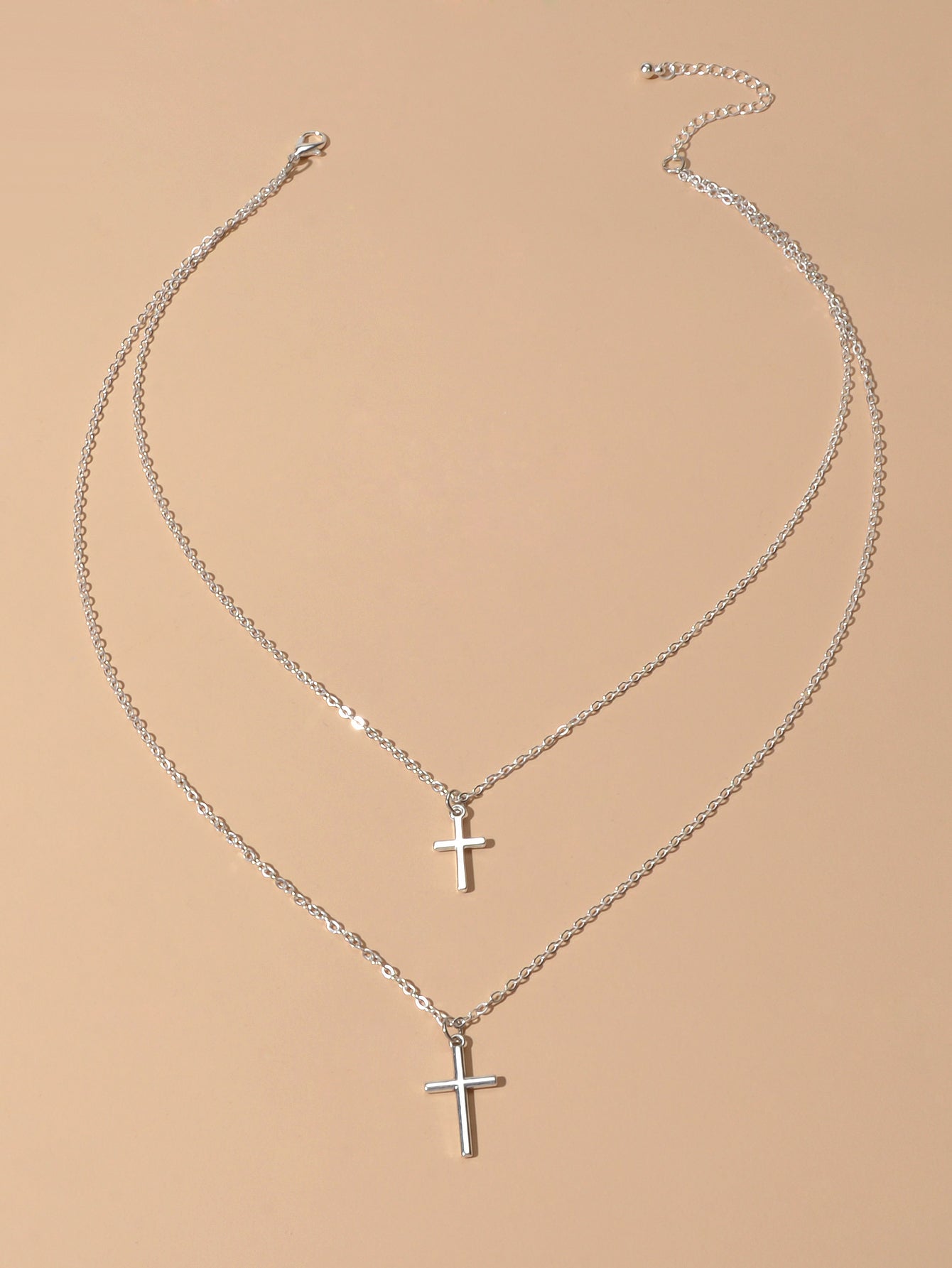 Silver double layer cross necklace featuring delicate chains and a minimalist pendant for women — view 2