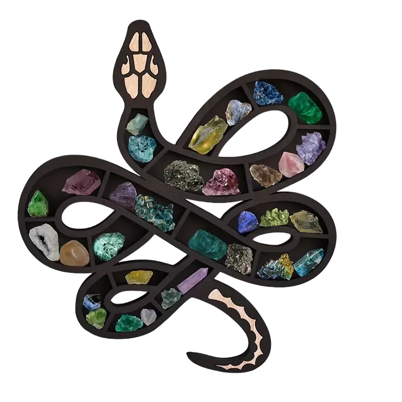 Black wooden snake shaped wall shelf displaying crystals and small plants on a wall