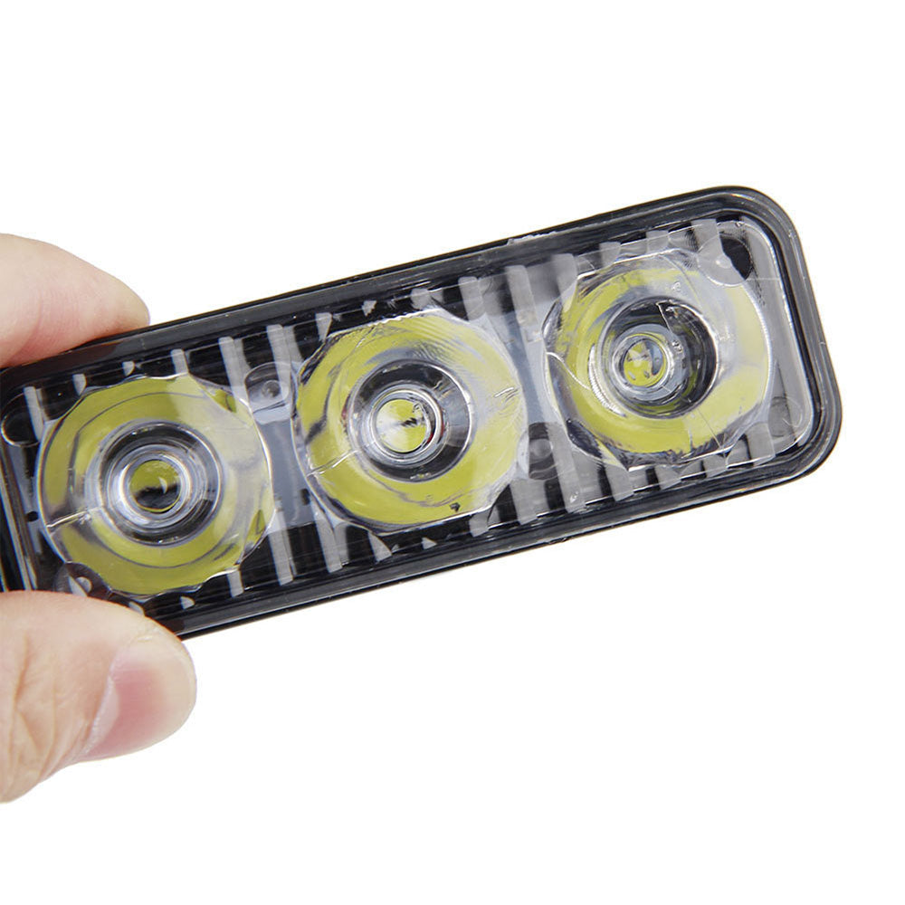 Black aluminum 3-LED daytime running lights with cool white beams and adjustable mounting brackets — view 4