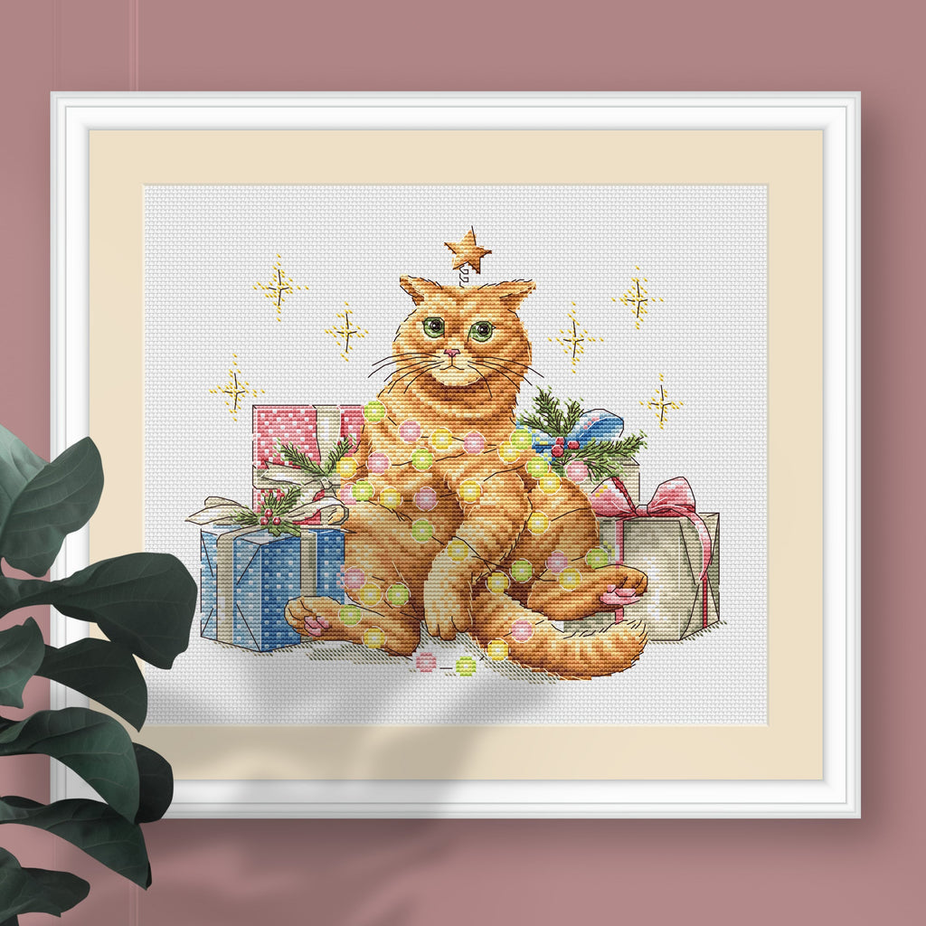 Festive orange cat cross stitch pattern design featuring colorful garland and a Christmas star.