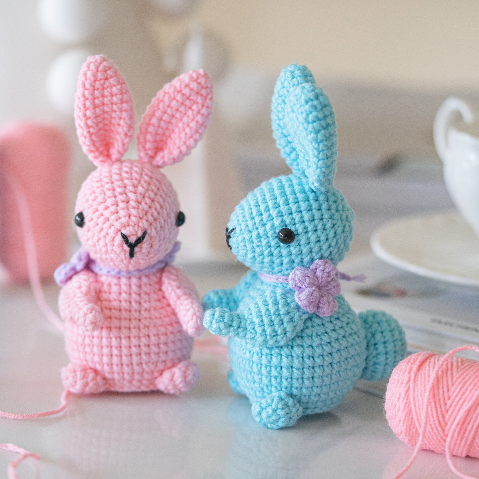 Rabbit amigurumi crochet kit showing finished plush bunny, premium threads, hook, and instructions — view 2