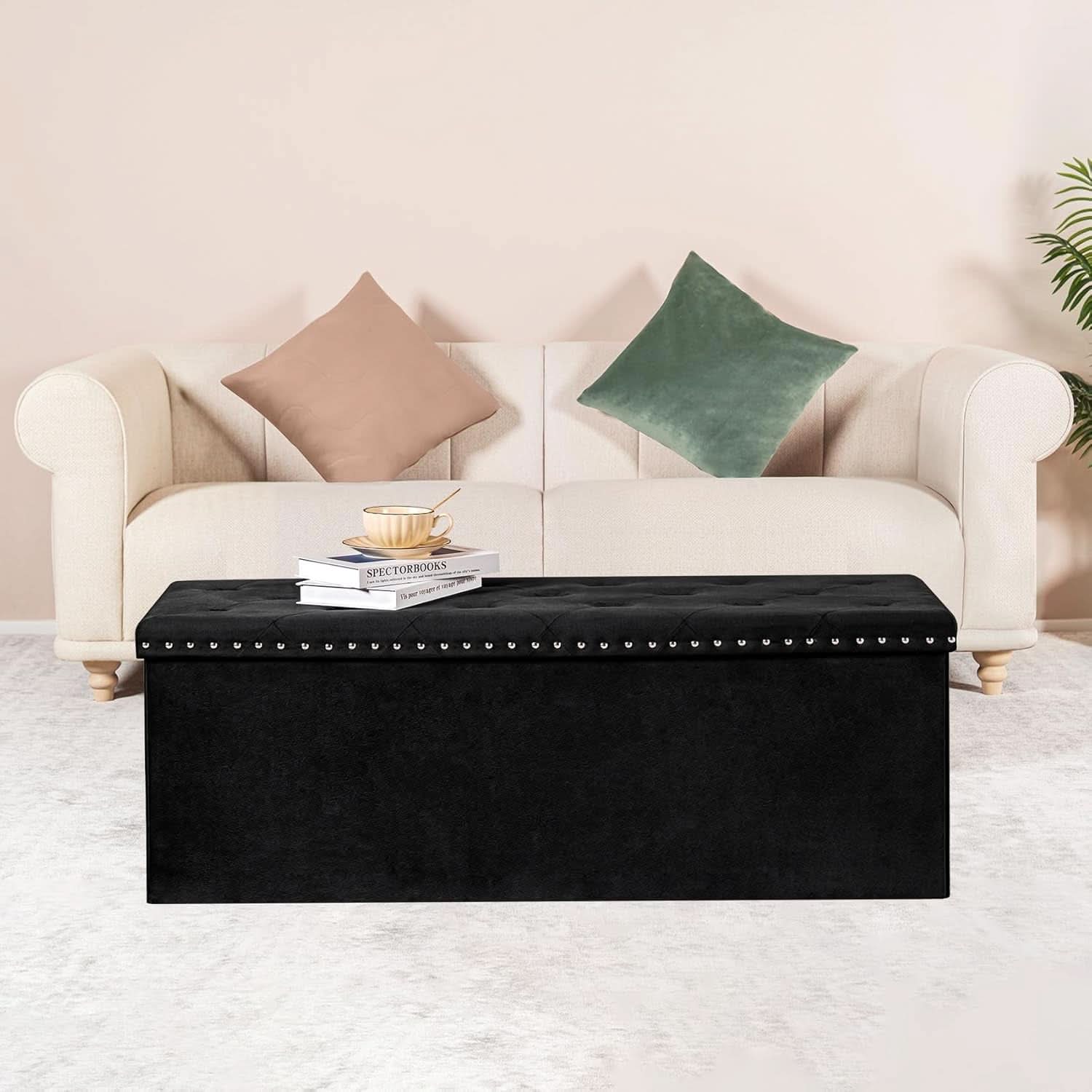 Black velvet storage ottoman bench with plush cushion, open to show hidden interior compartment space — view 2