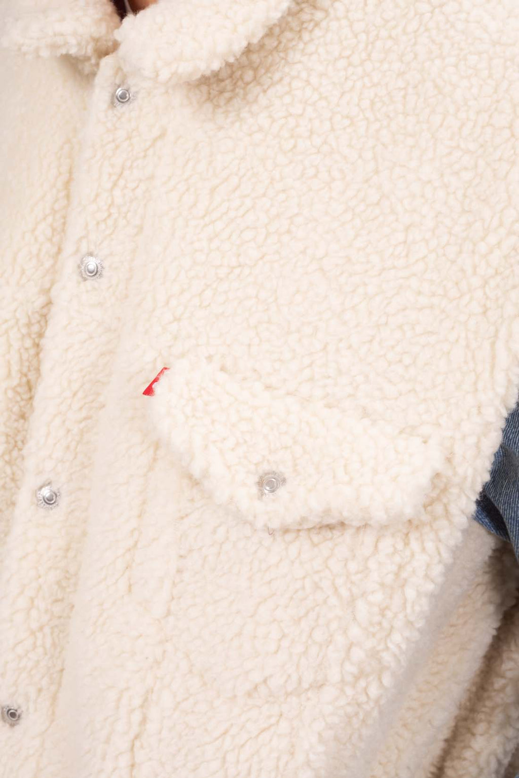 Men's colorblock jacket combining denim and fleece with snap buttons and front flap pockets — view 2